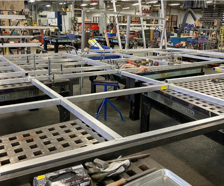 Workshop with metal tables and various tools.